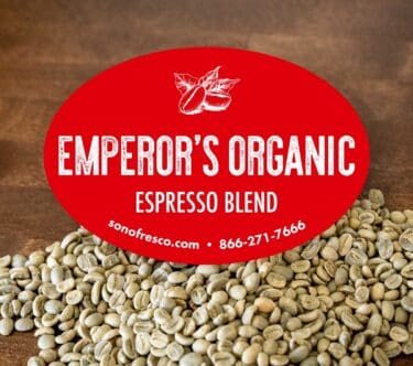 Emperor's Organic Espresso Blend - Rich Fusion of Flavors, with Vibrant Green Coffee Beans in the Background