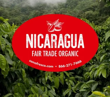 Nicaragua Fair Trade Organic coffee label over lush green coffee plants