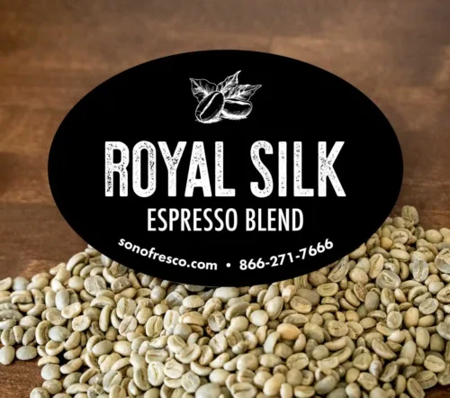 Royal Silk Espresso Blend label displayed in front of bags of green coffee beans.