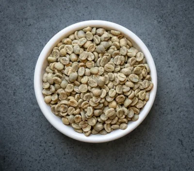 Uganda organic UTZ green coffee beans in a white bowl
