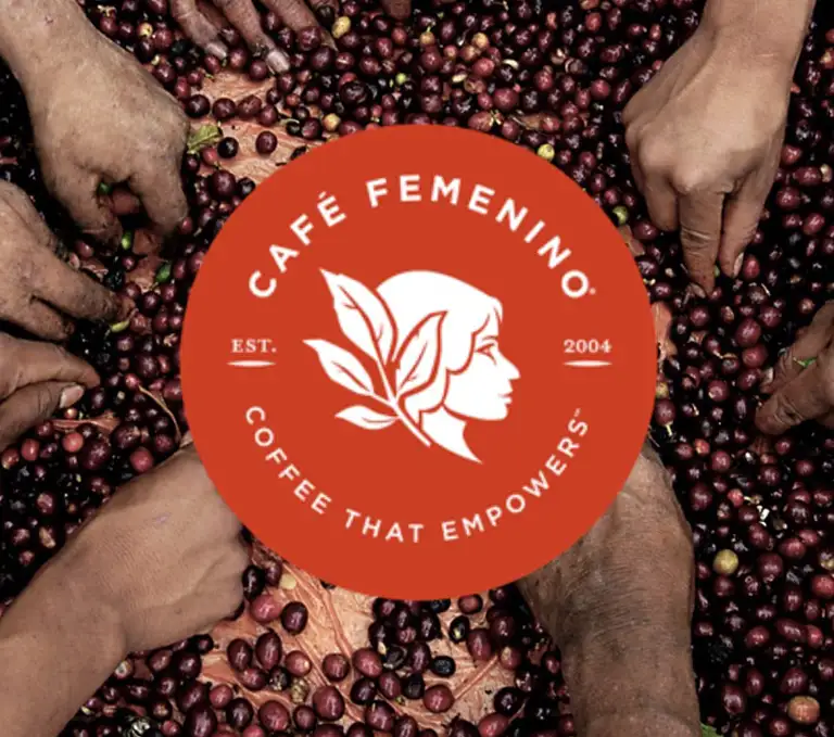 Café Femenino Coffee Program Logo Café Femenino logo over fresh coffee cherries harvested by women farmers
